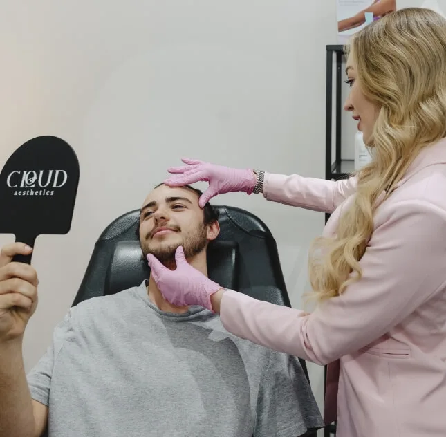 Practitioner with a male client using the Cloud Aesthetics branded mirror