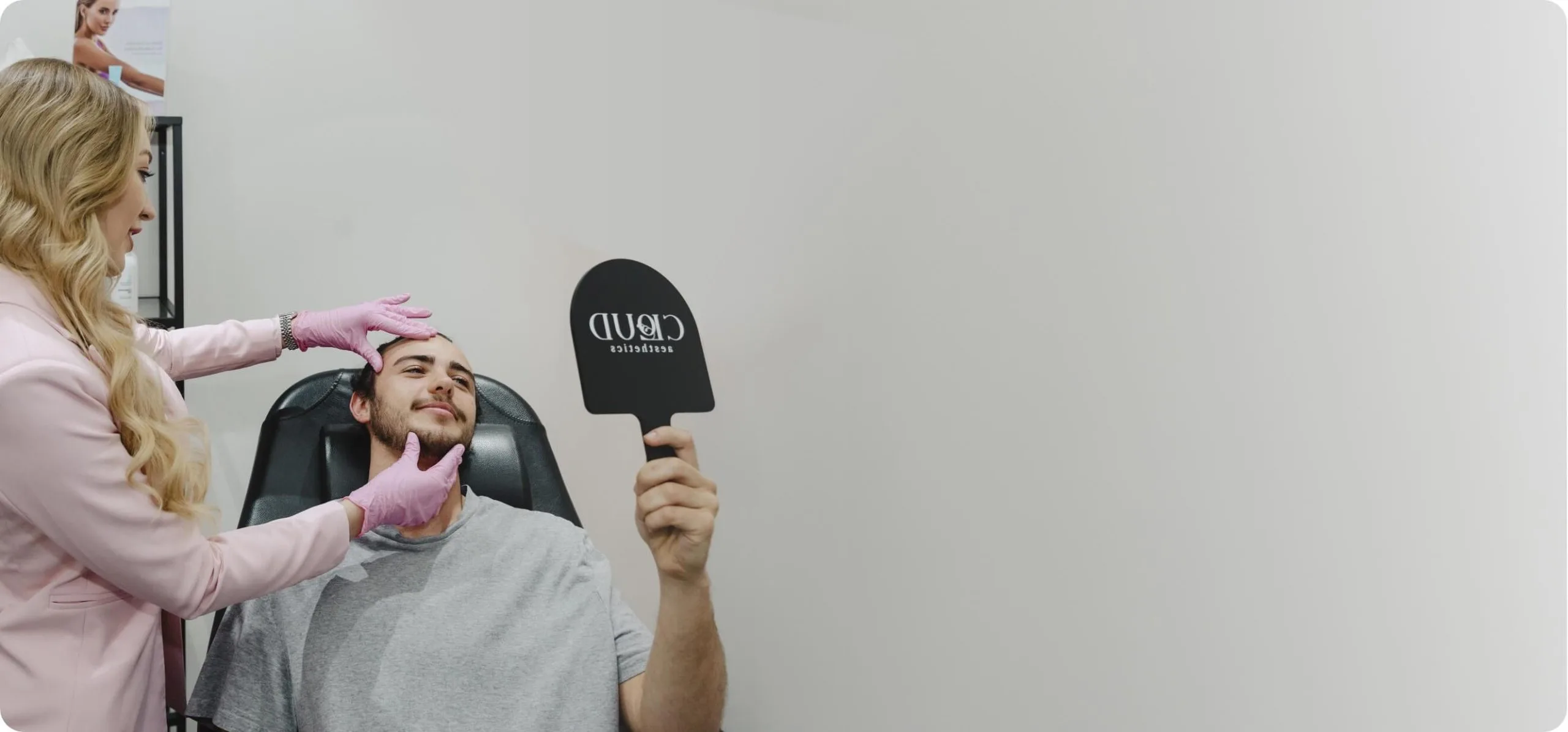 Practitioner framing a male client's face during consultation